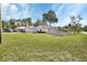 Charming home featuring a well-manicured front lawn and a white picket fence enhancing its curb appeal at 1020 N Orange Ave, Orange City, FL 32763