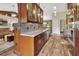 Open kitchen with dark wood cabinets, stainless appliances, granite countertops, and hardwood floors at 1020 N Orange Ave, Orange City, FL 32763