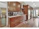 Bright kitchen featuring wood cabinets, granite countertops, stainless steel appliances, and hardwood floors at 1020 N Orange Ave, Orange City, FL 32763