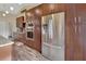 Spacious kitchen featuring stainless steel appliances, wood cabinets, tile backsplash, and wood floors at 1020 N Orange Ave, Orange City, FL 32763