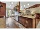 Stylish kitchen with dark wood cabinets, stainless appliances, granite countertops, and hardwood floors at 1020 N Orange Ave, Orange City, FL 32763