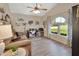 Cozy living room featuring vaulted ceiling, wood-look floors, and bright arched window at 1020 N Orange Ave, Orange City, FL 32763