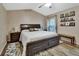 Cozy main bedroom featuring a decorative accent wall, natural light, and hardwood floors at 1020 N Orange Ave, Orange City, FL 32763