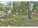Spacious backyard featuring a black wooden fence, mature trees, and a well-maintained lawn at 1020 Orange Camp Rd, Deland, FL 32724