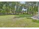 Expansive backyard with mature trees and a well-maintained lawn, enclosed by a black wooden fence at 1020 Orange Camp Rd, Deland, FL 32724