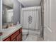 Bathroom featuring a single sink vanity, neutral walls, white door, and a decorative shower curtain at 1020 Orange Camp Rd, Deland, FL 32724