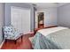 A bedroom features wood floors, a floral chair, and an attached sitting area at 1020 Orange Camp Rd, Deland, FL 32724