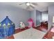 Bedroom with hardwood floors, neutral walls, a ceiling fan, and play tents at 1020 Orange Camp Rd, Deland, FL 32724