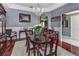 Elegant dining room with a chandelier, hardwood floors, and natural lighting from large windows at 1020 Orange Camp Rd, Deland, FL 32724