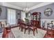 Elegant dining room featuring a chandelier, cherry wood table and chairs, and natural lighting at 1020 Orange Camp Rd, Deland, FL 32724