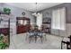 Cozy dining area featuring dark wood furniture, stylish decor, and ample natural light at 1020 Orange Camp Rd, Deland, FL 32724