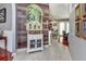 Inviting entryway featuring a decorative wall with artistic painting, and decorative white cabinet, leading into the living area at 1020 Orange Camp Rd, Deland, FL 32724