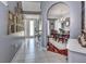 Inviting entryway showcasing tile flooring and an arched entrance into the formal dining room with chandelier at 1020 Orange Camp Rd, Deland, FL 32724