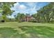 Lovely brick two-story home with a perfectly manicured lawn, mature trees, and meticulous landscaping at 1020 Orange Camp Rd, Deland, FL 32724