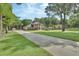 Two-story brick home on a large lot with an extended driveway and mature trees in a lush lawn at 1020 Orange Camp Rd, Deland, FL 32724