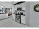 Bright kitchen featuring white cabinets, stainless steel appliances, and black countertops at 1020 Orange Camp Rd, Deland, FL 32724