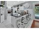 Open kitchen design featuring a bar countertop with stools, white cabinets, and stainless steel appliances at 1020 Orange Camp Rd, Deland, FL 32724