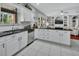 Modern kitchen with white cabinets, stainless steel appliances, and an open layout to the living area at 1020 Orange Camp Rd, Deland, FL 32724