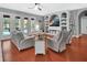Open living room with french doors to the pool area and built-in shelves with TV at 1020 Orange Camp Rd, Deland, FL 32724