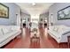 Living room with hardwood floors, neutral walls, white couches, vaulted ceilings, and recessed lighting at 1020 Orange Camp Rd, Deland, FL 32724