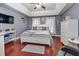 Spacious main bedroom with tray ceilings, cherry floors, and an abundance of natural light at 1020 Orange Camp Rd, Deland, FL 32724