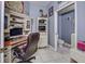 Home office featuring a large wooden desk, built-in shelving, and a view into an adjacent bathroom at 1020 Orange Camp Rd, Deland, FL 32724