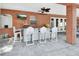 Outdoor bar area with brick accents, TV, pizza oven, granite countertop, and stylish seating at 1020 Orange Camp Rd, Deland, FL 32724