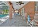 Covered patio featuring comfortable seating, brick pillars, and outdoor access near the backyard at 1020 Orange Camp Rd, Deland, FL 32724