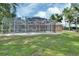 Screened in pool surrounded by nice seating on a beautifully manicured lawn in the backyard at 1020 Orange Camp Rd, Deland, FL 32724