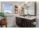 Bright bathroom with a double vanity, modern fixtures, and ample natural light at 10460 Burrows St, Orlando, FL 32832