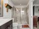 Modern bathroom with a glass shower enclosure, stylish vanity, and contemporary fixtures at 10460 Burrows St, Orlando, FL 32832