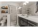 Modern bathroom with tiled shower, glass enclosure, and spacious vanity at 10460 Burrows St, Orlando, FL 32832