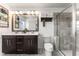 Elegant bathroom features a double sink vanity, modern fixtures, and tiled walk-in shower at 10460 Burrows St, Orlando, FL 32832