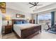 Comfortable bedroom with a spacious layout, a ceiling fan, and large window for natural light at 10460 Burrows St, Orlando, FL 32832