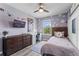 Cozy bedroom with wood accent wall, modern furnishings, and stylish decor at 10460 Burrows St, Orlando, FL 32832