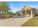 Community space with bench, patio, lush landscaping, and walkway to pool at 10460 Burrows St, Orlando, FL 32832