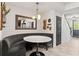Stylish dining area featuring a built-in booth and modern lighting fixtures for a cozy atmosphere at 10460 Burrows St, Orlando, FL 32832