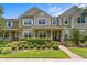 Charming two-story townhouse featuring a well-manicured lawn and an inviting front porch at 10460 Burrows St, Orlando, FL 32832