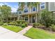 Beautiful townhouse with lush green lawn and landscaped garden leading to the front entrance at 10460 Burrows St, Orlando, FL 32832