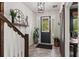 Welcoming foyer with tiled flooring, wood accents, and natural light streaming through the front door at 10460 Burrows St, Orlando, FL 32832