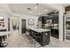 Modern kitchen with a central island, bar stool seating, and stainless steel appliances at 10460 Burrows St, Orlando, FL 32832