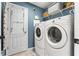 Functional laundry room features a washer, dryer, and storage shelves for added convenience at 10460 Burrows St, Orlando, FL 32832