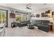 Bright and airy living room with neutral tones, tile floors, and large windows overlooking the patio at 10460 Burrows St, Orlando, FL 32832