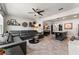 Open concept living room featuring tile floors, modern furnishings, and eat-in kitchen island with bar seating at 10460 Burrows St, Orlando, FL 32832
