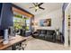 Home office featuring blue accent wall, natural light, and comfortable seating area at 10460 Burrows St, Orlando, FL 32832
