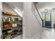 Pantry features wood shelves. Entryway with white staircase and blue front door with sidelights at 10460 Burrows St, Orlando, FL 32832