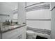 Bathroom features a white vanity, granite countertop, and striped shower curtain at 1094 Lolita St, Orange City, FL 32763