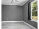 Another view of simple bedroom with gray walls and window at 1094 Lolita St, Orange City, FL 32763