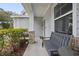 Charming covered front porch with seating and decorative exterior at 1094 Lolita St, Orange City, FL 32763
