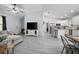 Bright, open-concept living room with hardwood floors and stainless steel kitchen appliances at 1094 Lolita St, Orange City, FL 32763